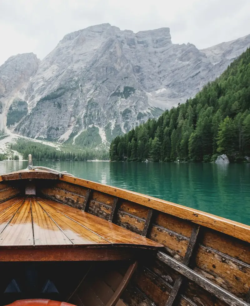 Holzboot auf einem türkisfarbenen Bergsee